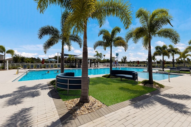 view of pool with a lawn and a patio