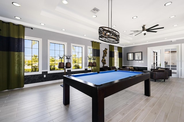 game room with ceiling fan, light hardwood / wood-style flooring, pool table, and a tray ceiling