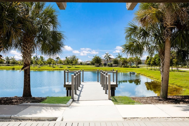 dock area featuring a water view and a yard