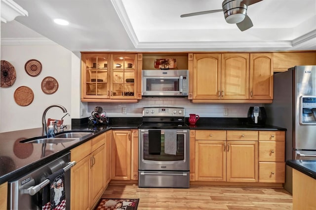 kitchen featuring appliances with stainless steel finishes, light wood-type flooring, tasteful backsplash, crown molding, and sink