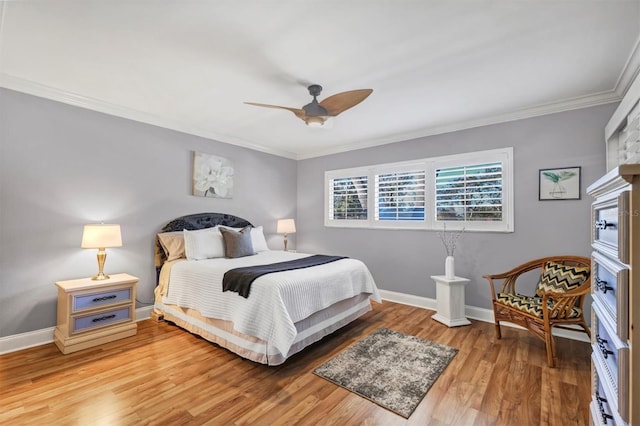 bedroom featuring hardwood / wood-style floors, ceiling fan, and crown molding