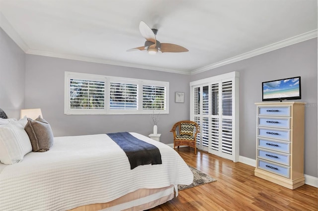 bedroom with hardwood / wood-style flooring, ceiling fan, and ornamental molding