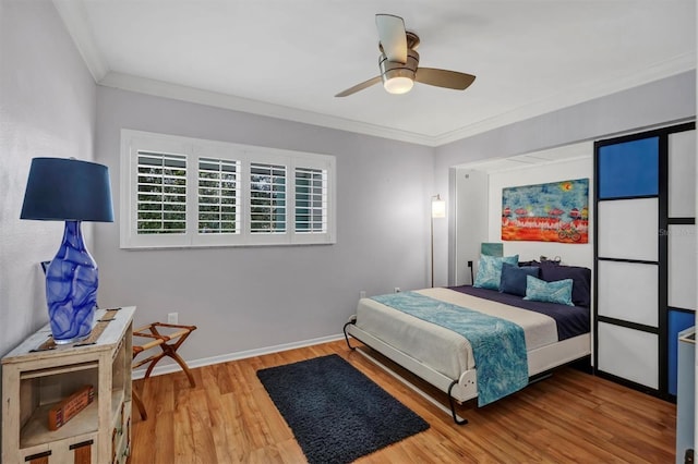 bedroom featuring hardwood / wood-style flooring, ceiling fan, and ornamental molding