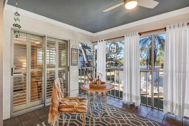 sunroom / solarium featuring ceiling fan