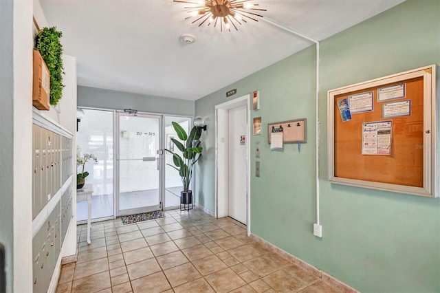 entryway featuring a mail area and light tile patterned flooring