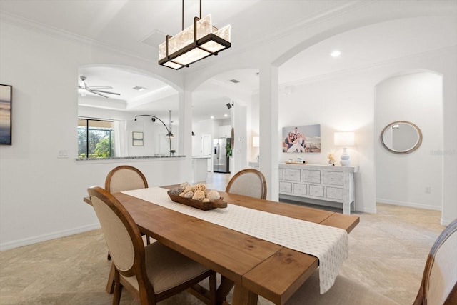 dining room with ceiling fan and crown molding