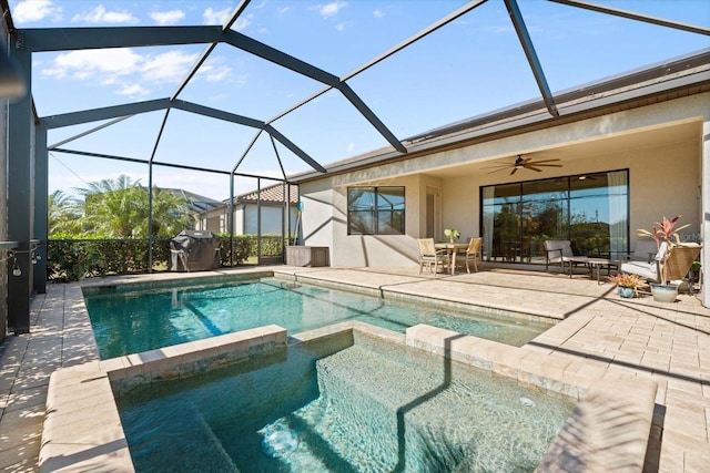 view of pool with glass enclosure, ceiling fan, an in ground hot tub, a grill, and a patio area