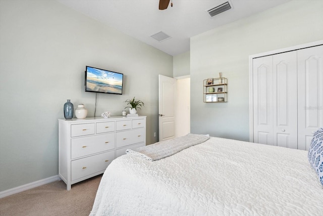 carpeted bedroom with ceiling fan and a closet