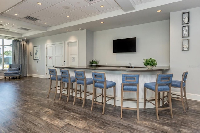 bar featuring dark hardwood / wood-style flooring and sink