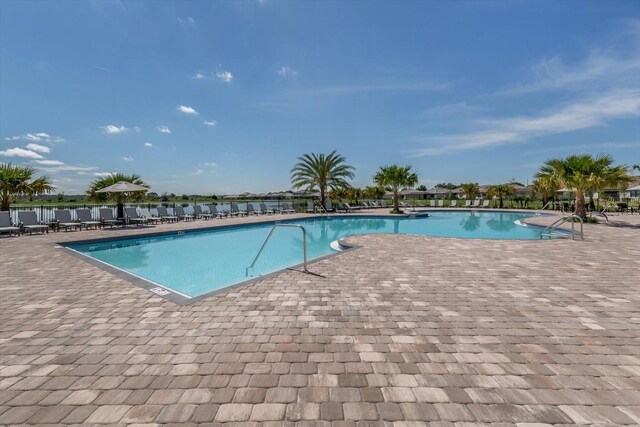 view of swimming pool featuring a patio area