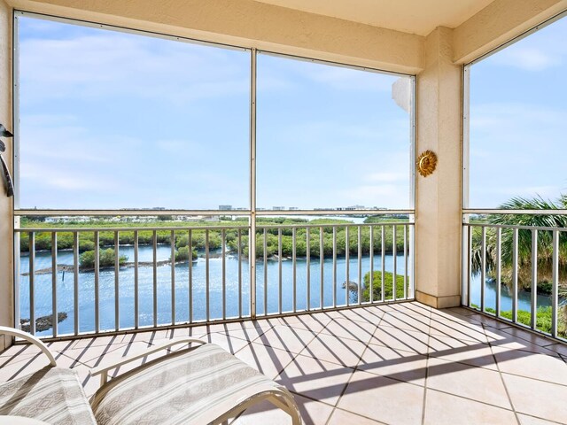 unfurnished sunroom featuring a water view