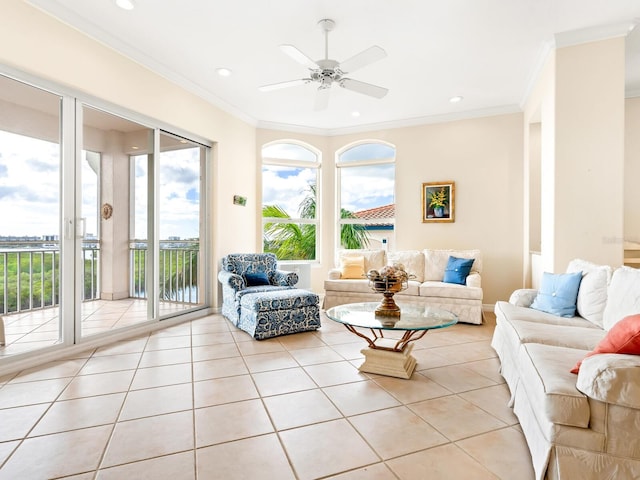 living room featuring ceiling fan, a wealth of natural light, and light tile patterned flooring