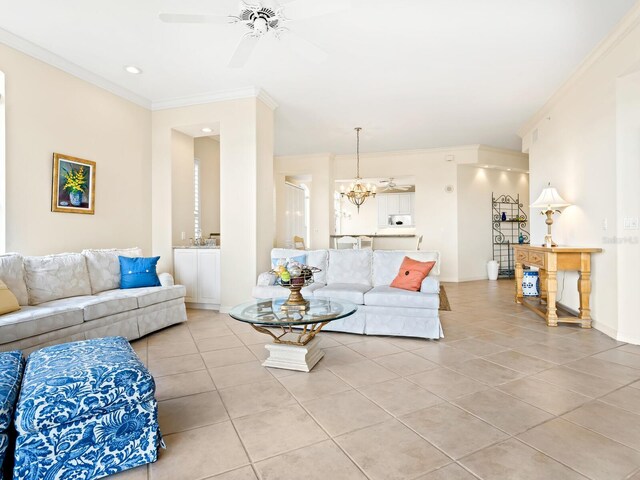 living room with ceiling fan with notable chandelier, ornamental molding, and light tile patterned flooring