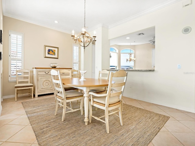 dining area with light tile patterned floors, ceiling fan with notable chandelier, and crown molding