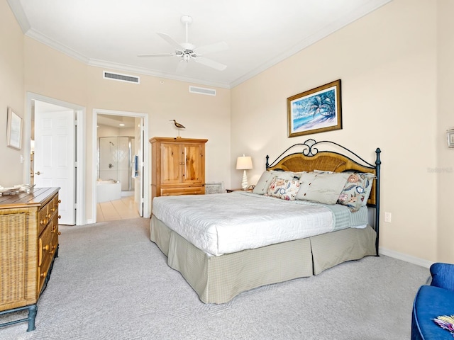 carpeted bedroom with ensuite bath, ceiling fan, and crown molding