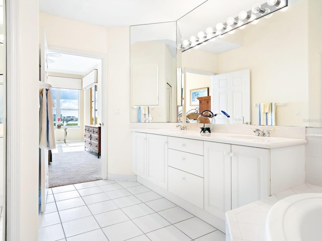 bathroom featuring tile patterned floors, vanity, and a bathtub