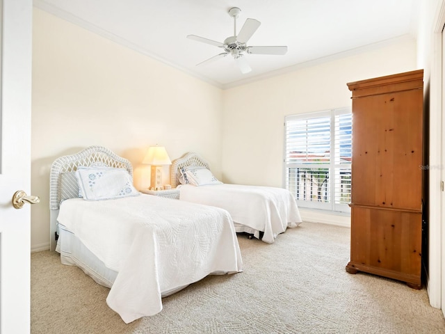 bedroom featuring carpet flooring, ceiling fan, and crown molding