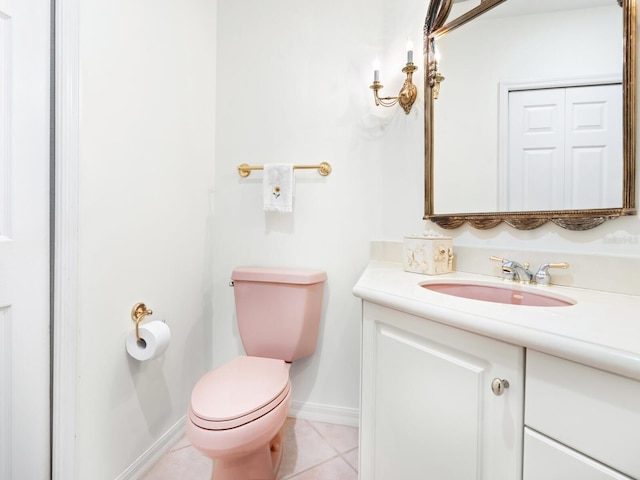 bathroom with tile patterned flooring, vanity, and toilet