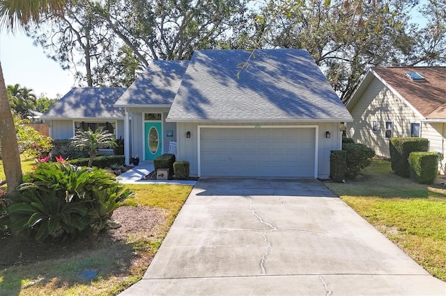 view of front facade featuring a front yard and a garage