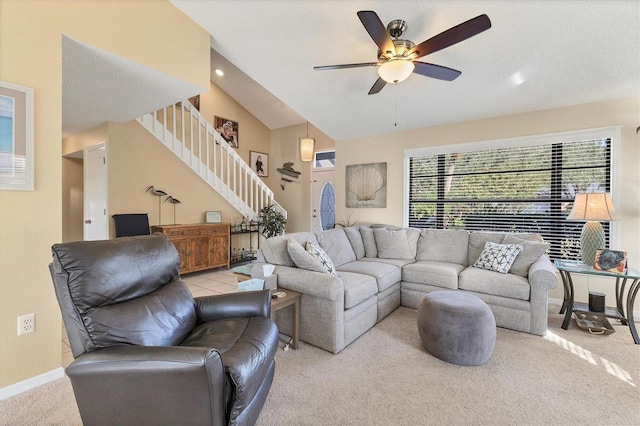 carpeted living room featuring ceiling fan and lofted ceiling