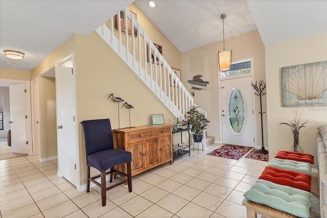 foyer with light tile patterned floors and a textured ceiling