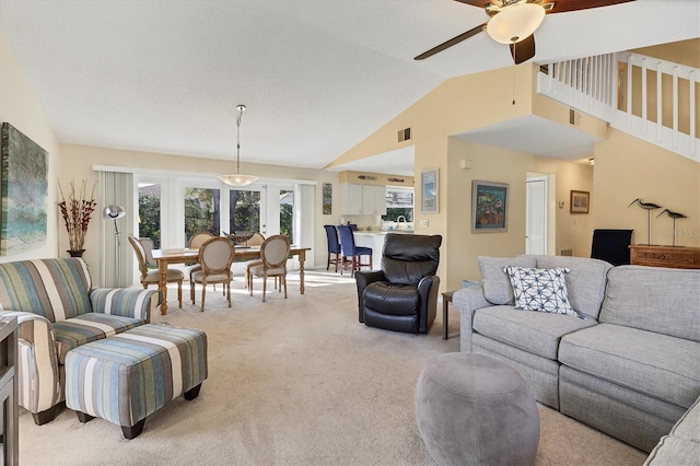 carpeted living room with vaulted ceiling and ceiling fan