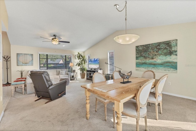 carpeted dining area featuring vaulted ceiling and ceiling fan