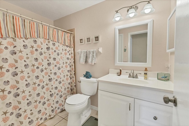 bathroom with tile patterned flooring, vanity, toilet, and walk in shower