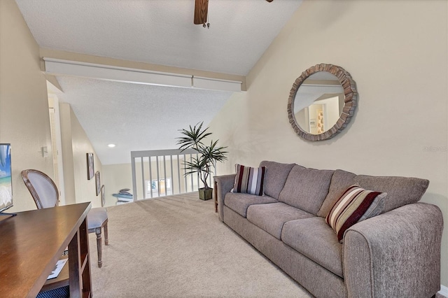 carpeted living room featuring vaulted ceiling with beams and a textured ceiling