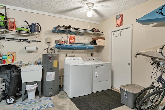 laundry area with a textured ceiling, electric water heater, washer and clothes dryer, and ceiling fan