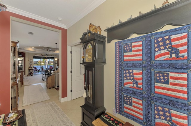 hallway featuring light tile patterned floors and crown molding