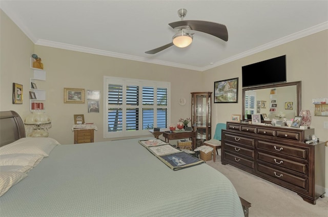 carpeted bedroom featuring ceiling fan and ornamental molding