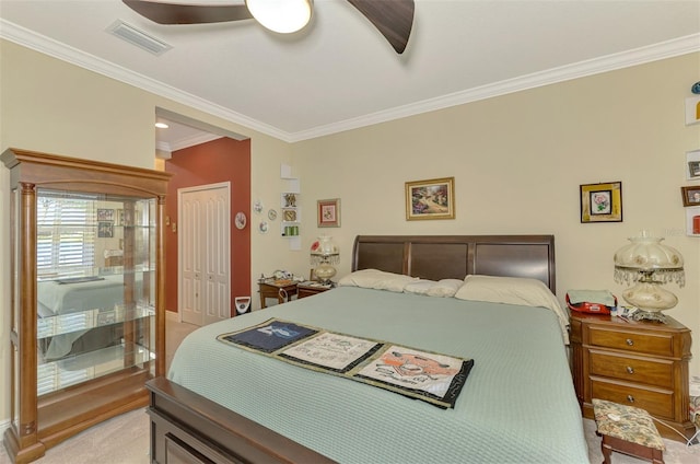 bedroom with light carpet, a closet, ceiling fan, and ornamental molding