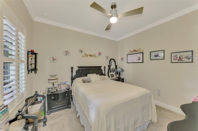 carpeted bedroom featuring ceiling fan and crown molding