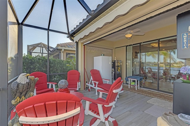 wooden deck with ceiling fan and a lanai