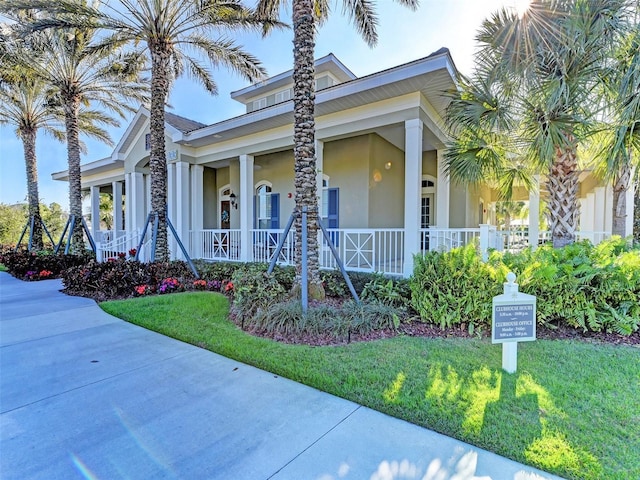 view of front of house with a porch and a front lawn