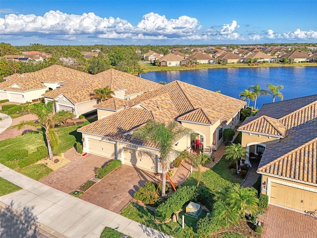 drone / aerial view with a residential view and a water view