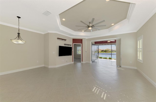 unfurnished living room featuring baseboards, visible vents, a raised ceiling, a ceiling fan, and ornamental molding