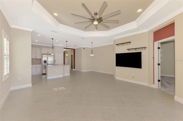 unfurnished living room with baseboards, a raised ceiling, a ceiling fan, crown molding, and recessed lighting