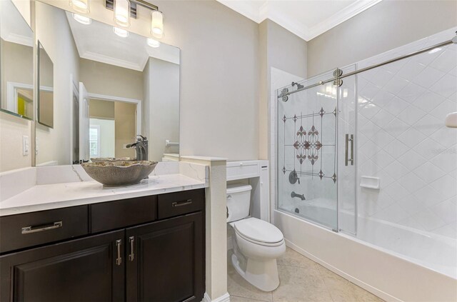 full bathroom with combined bath / shower with glass door, crown molding, toilet, and tile patterned floors