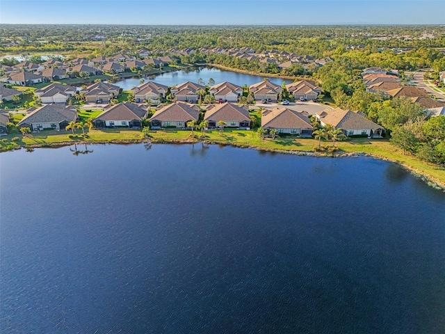 drone / aerial view with a water view and a residential view