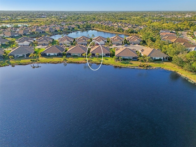 birds eye view of property featuring a water view and a residential view