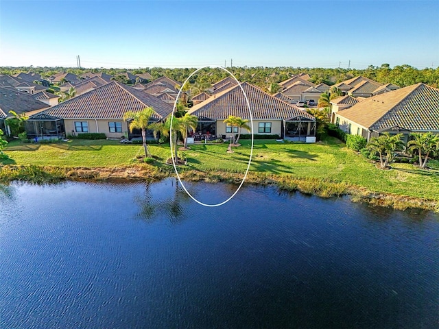 drone / aerial view with a residential view and a water view