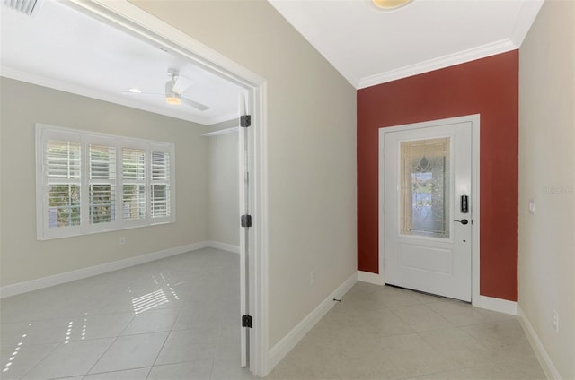 entrance foyer featuring crown molding, light tile patterned floors, visible vents, a ceiling fan, and baseboards