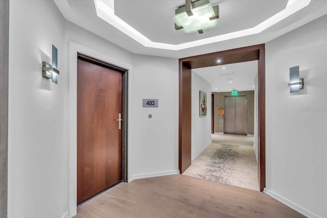 corridor with light hardwood / wood-style floors