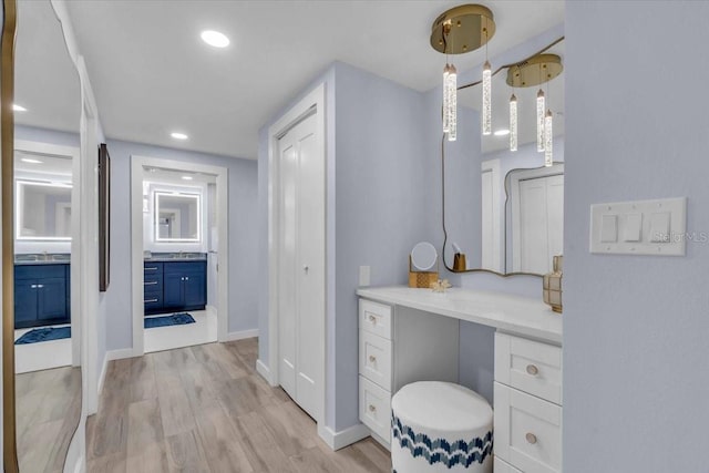 bathroom with wood-type flooring and vanity