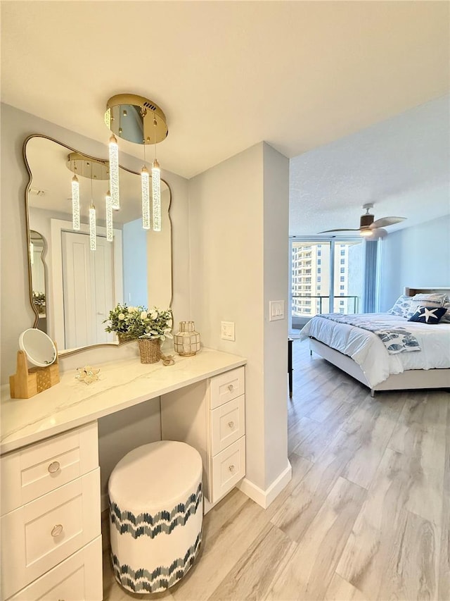 bathroom with ceiling fan and hardwood / wood-style floors