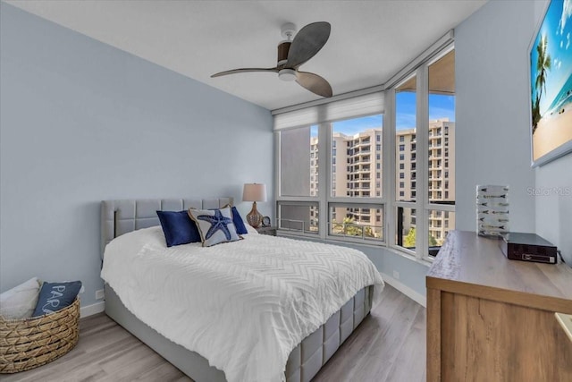 bedroom featuring light wood-type flooring and ceiling fan