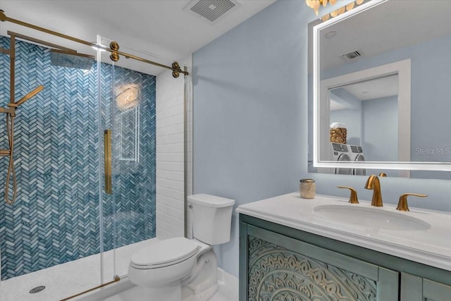 bathroom featuring a shower with door, vanity, and toilet