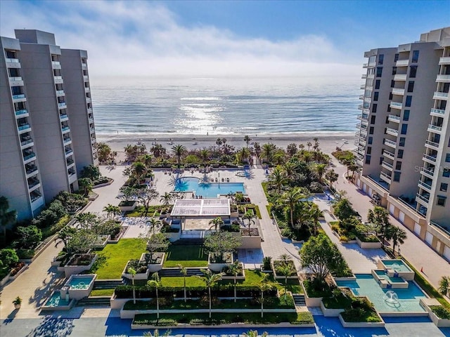 birds eye view of property featuring a view of the beach and a water view